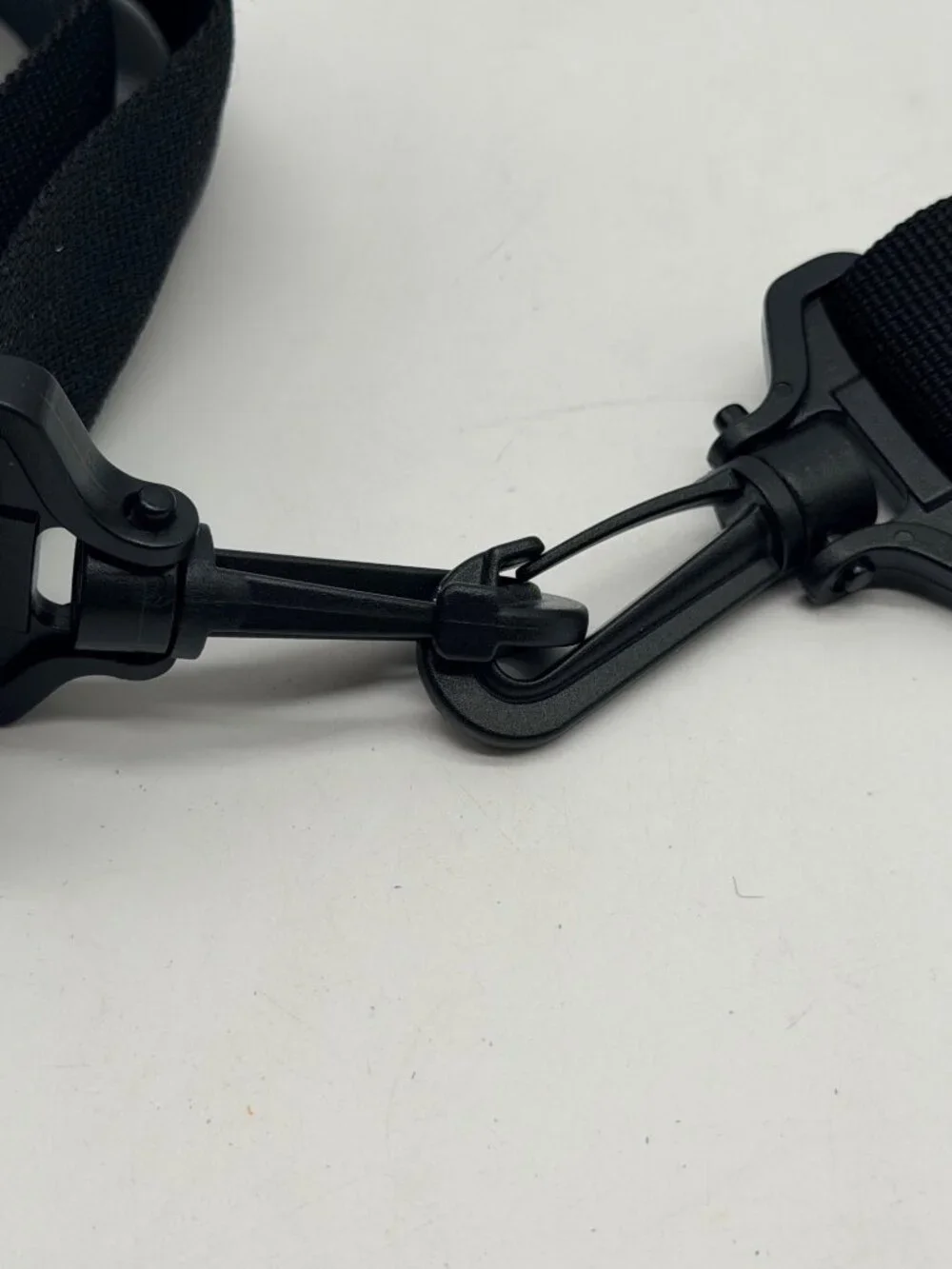 black Canon padded camera shoulder strap featuring an adjustable nylon web belt